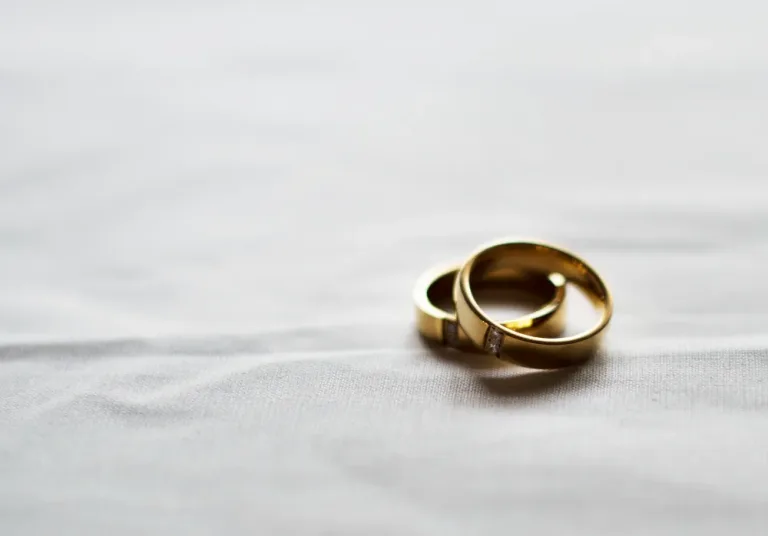 Two gold wedding rings on a table