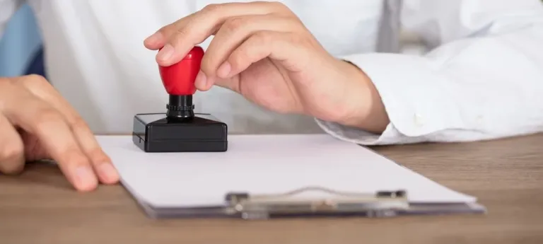 A person stamping a document