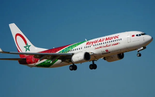 A Royal Air Maroc aircraft flying against a blue sky
