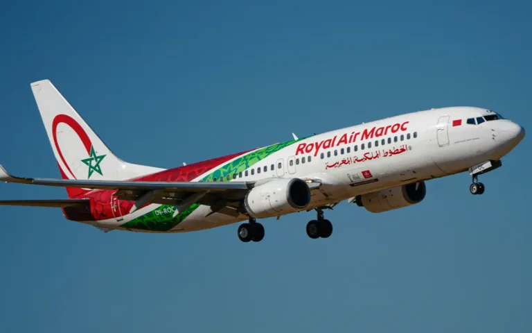 A Royal Air Maroc aircraft flying against a blue sky