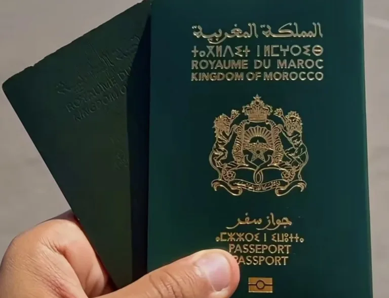 A hand holding two Moroccan passports